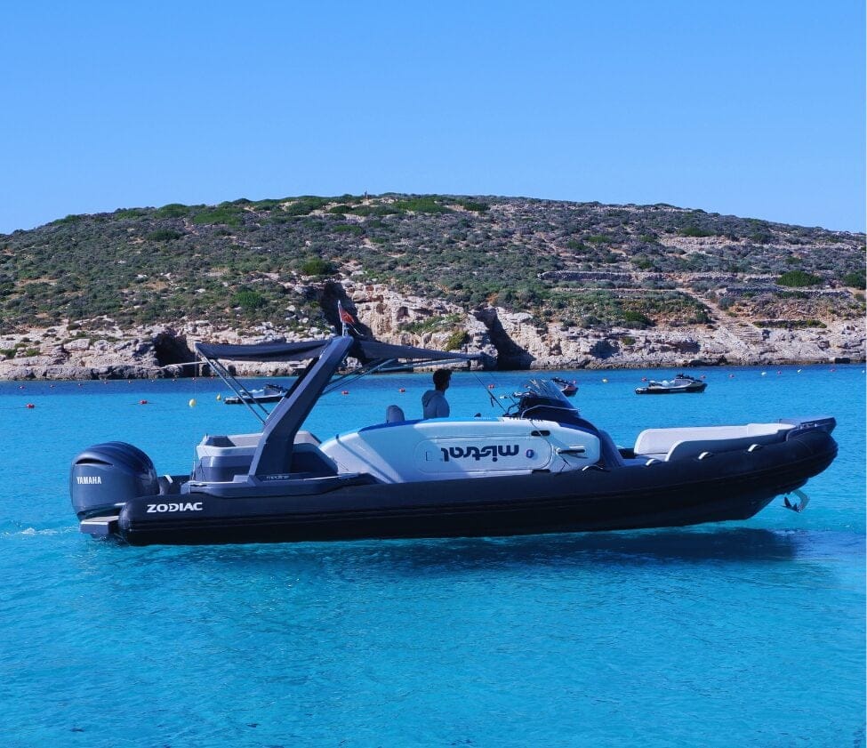 A Zodiac RIB cruising off the Comino coast