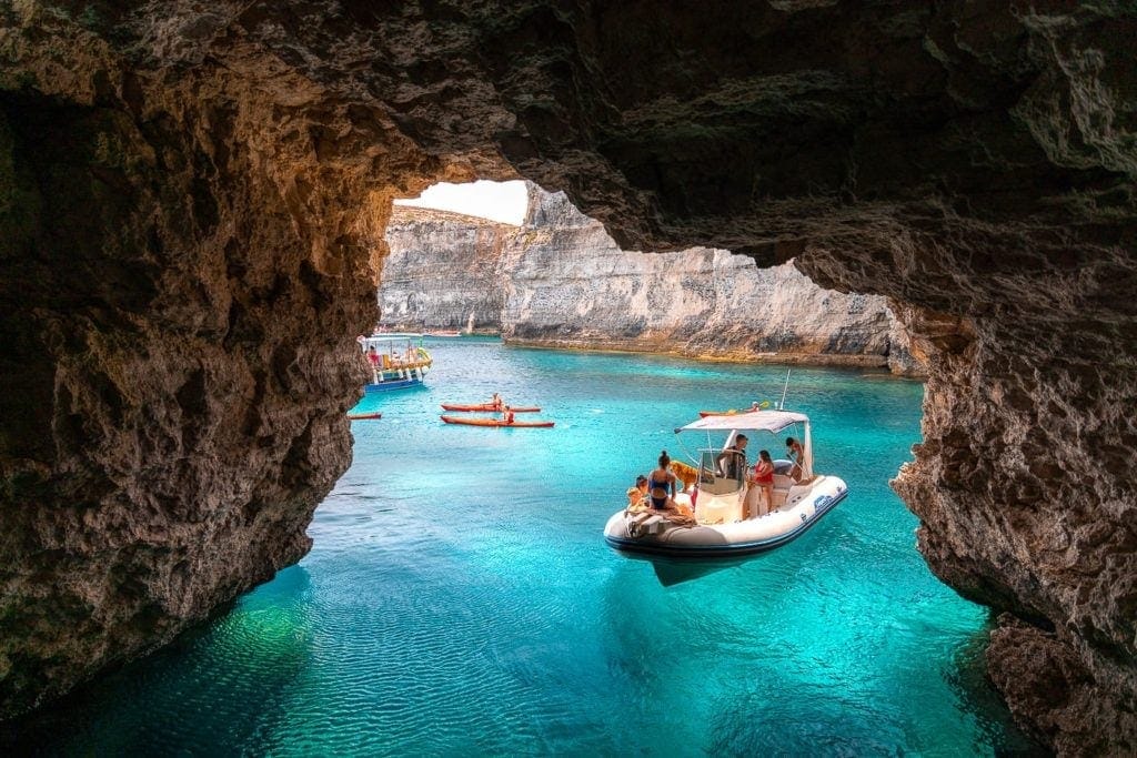 Seen from a boat through a Comino sea cave arch