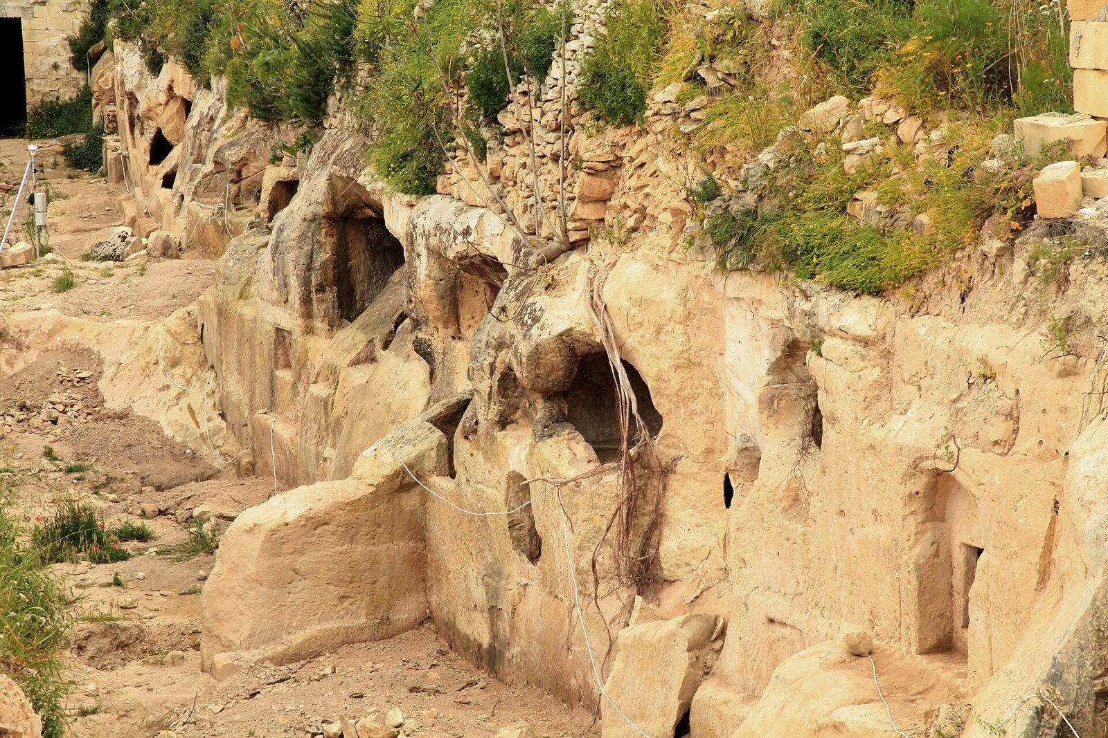 Close view of a rock-cut burial chamber at Ta' Bistra with a carved table surface
