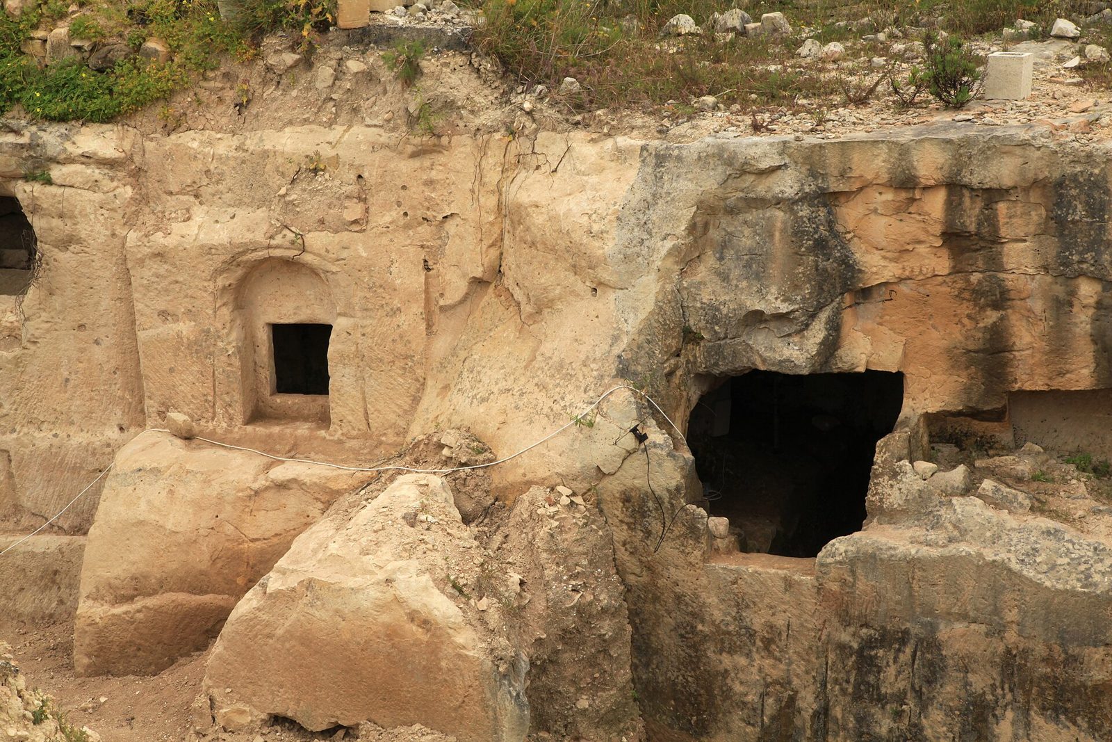 A row of rock-cut tomb openings and window tombs at Ta' Bistra Catacombs