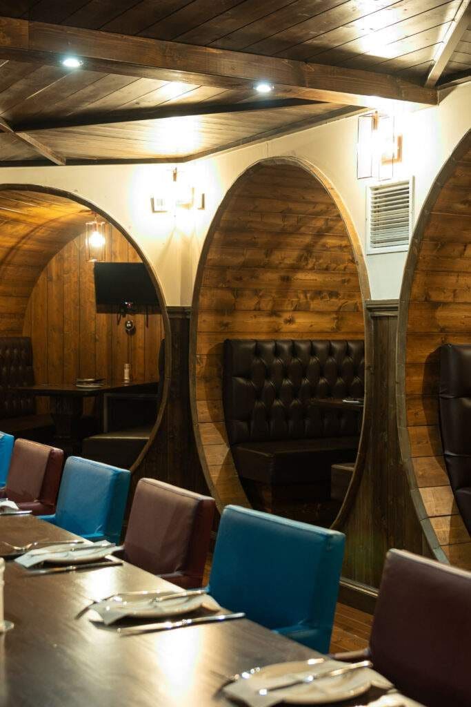 Interior with wooden barrel-style alcoves and leather seating