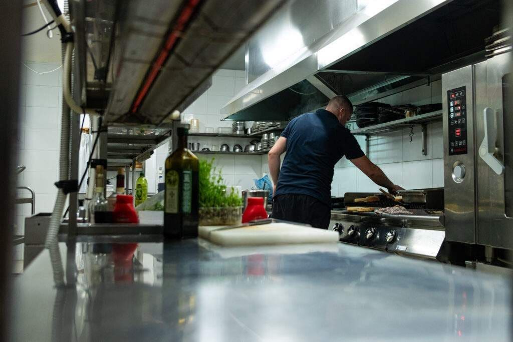 A chef working in a professional steel kitchen