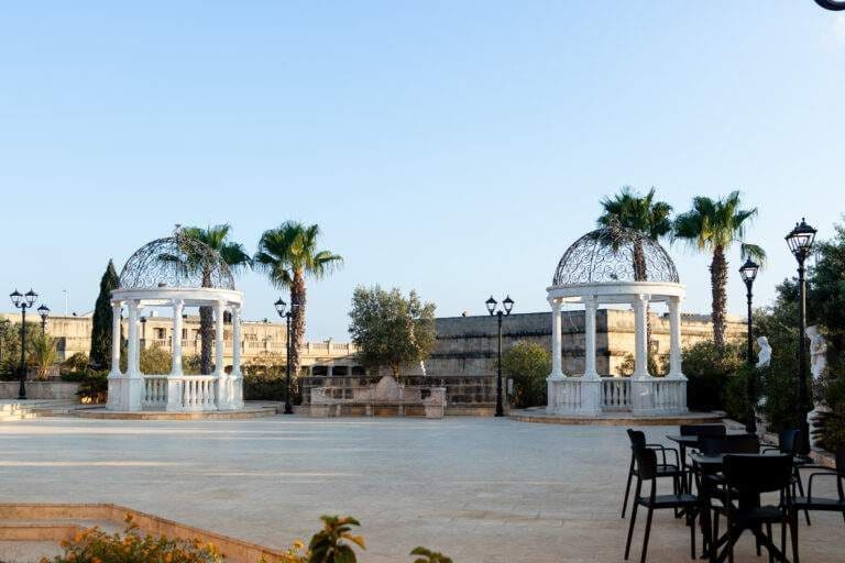 White gazebos and palm trees at The Roof Garden