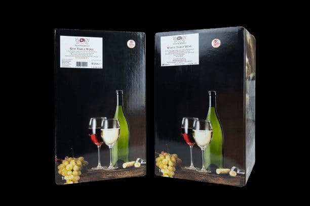Two black boxes of Montekristo table wine with a glass of red, a glass of white and a bunch of grapes pictured on the front