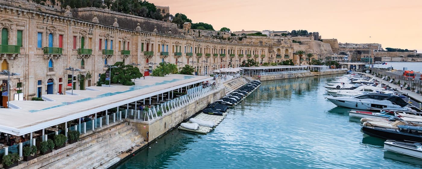 The restored harbourside stores of the Valletta Waterfront with moored boats