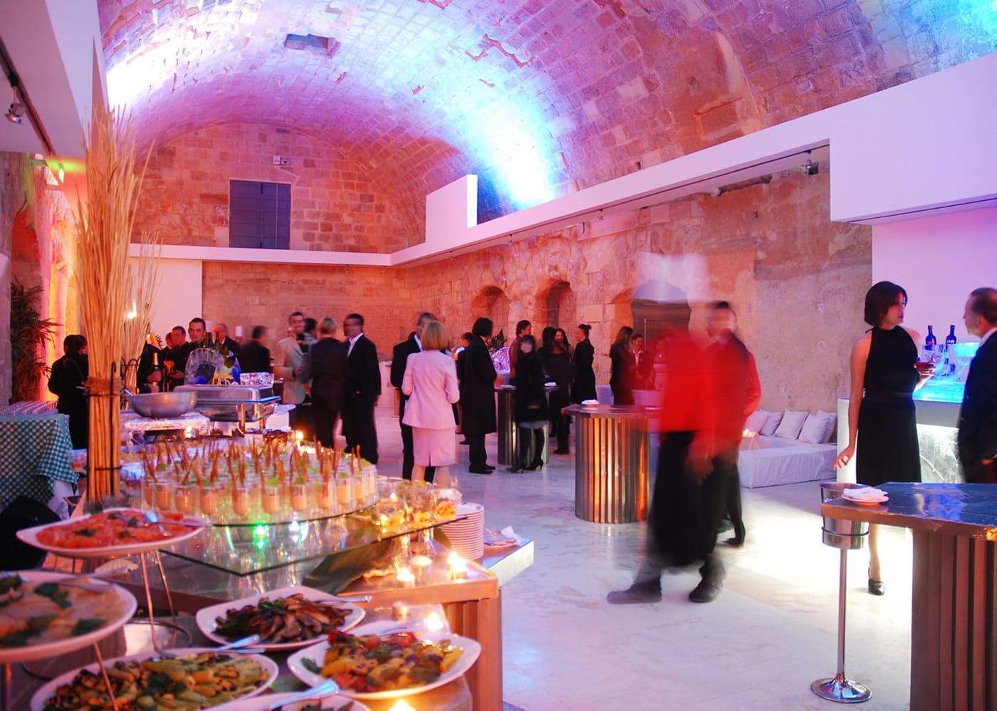 Guests at a reception in the arched Magazino Hall