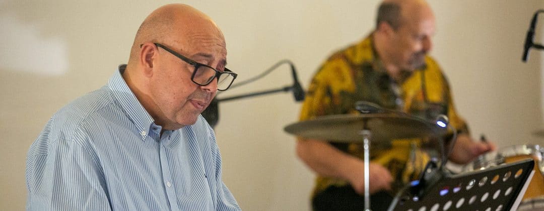 A jazz pianist and drummer performing