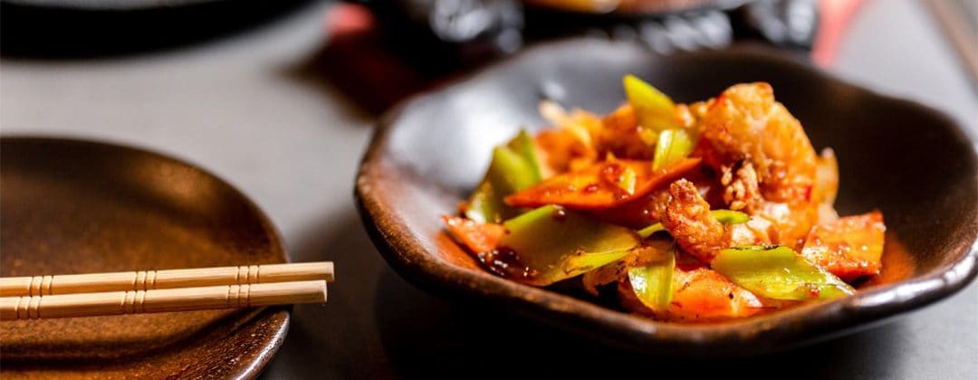 A colourful stir-fried Asian dish served in a bowl
