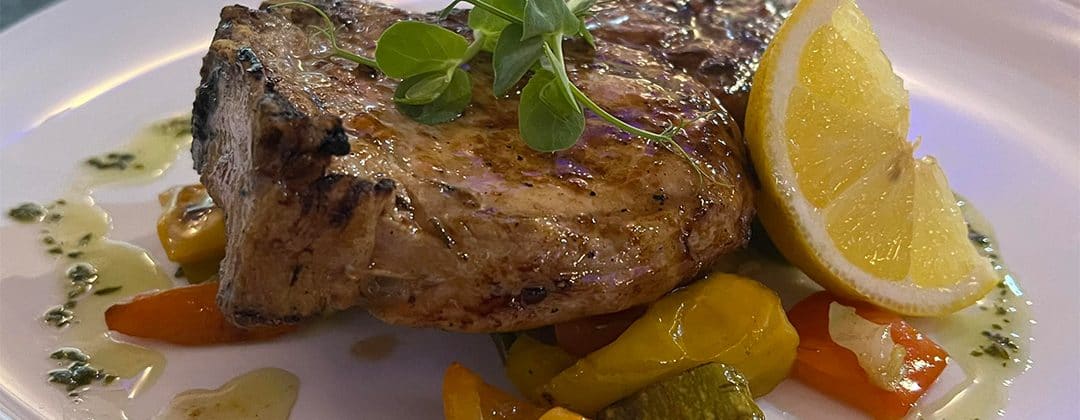 Grilled meat with lemon and peppers served at Bistro 516