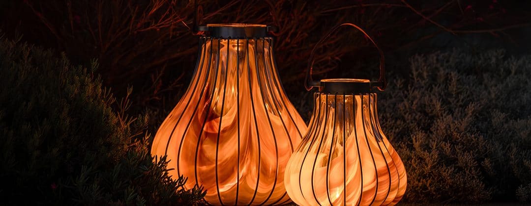 Two glowing amber glass lanterns at night